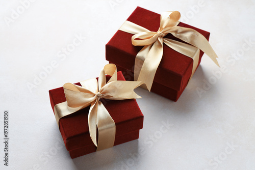 Two beautiful red gift boxes on white table