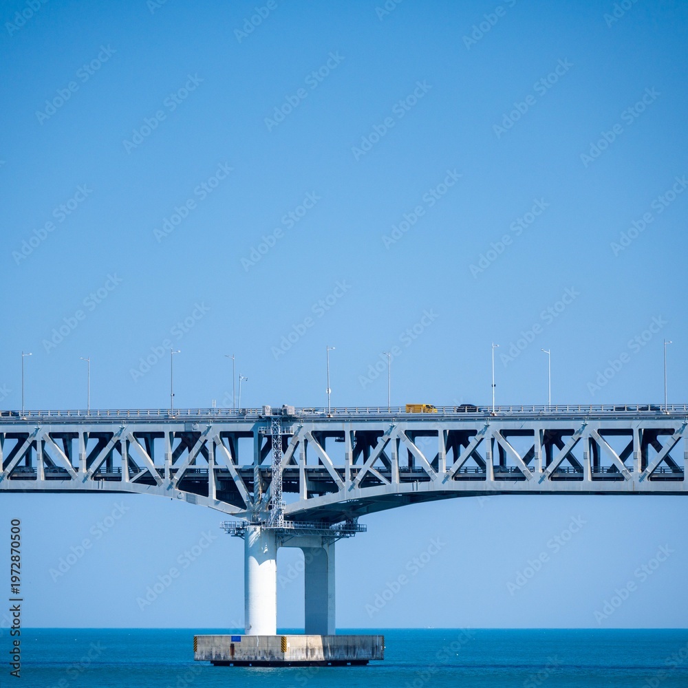 Obraz premium Railway bridge over the sea with blue sky in summer day.