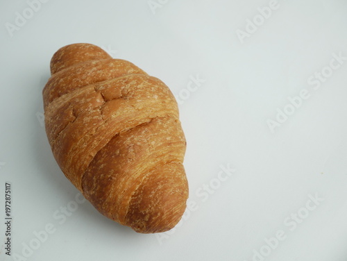 Canvas Print Freshly baked golden croissant on white background