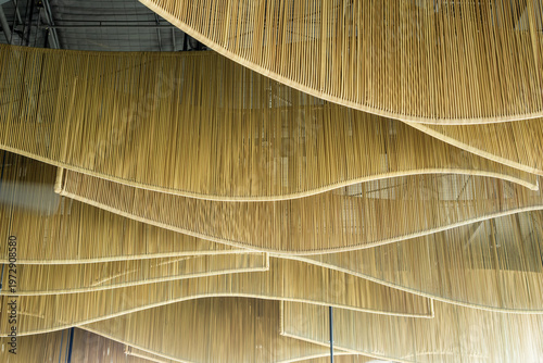 Abstract ceiling design with layered golden lines forming wave patterns, modern architectural interior detail with luxury aesthetic concept.