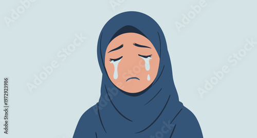 Sad woman wearing a blue hijab crying.