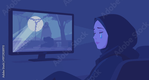 woman wearing hijab sitting in front of computer screen.