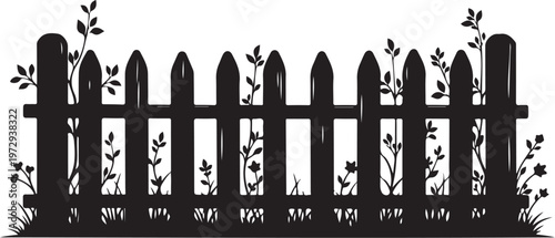Black picket fence with plants growing through and around it