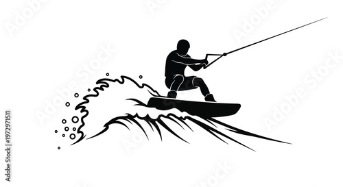 A black silhouette of a waterskier riding a wave with spray
