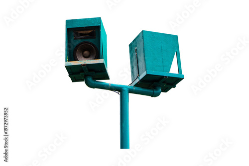 Address loudspeaker mounted green old on metal pole in park environment. Twin speakers for announcements, safety warnings, and communication systems. Isolated on cutout PNG or transparent background.
