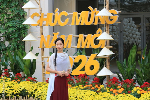 Model standing in front of a Vietnamese Happy New Year sign for TET. 