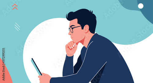 Young man with glasses sitting and looking thoughtfully at a tablet screen while resting his chin on his hand.