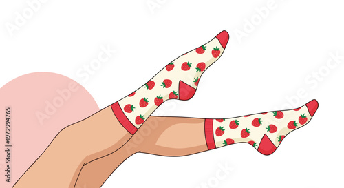 Pair of legs raised in the air wearing white socks adorned with cute red strawberry patterns and red trim against a soft pink background.