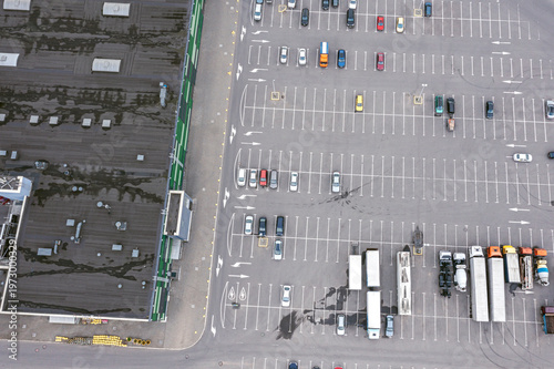 aerial view of cars at large outdoor parking lot near city shopping mall. drone photo.