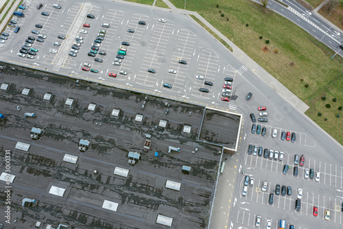aerial view of parked cars on a parking lot of supermarket. top view from drone.