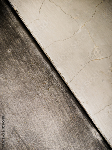 Close-up of abstract concrete wall surface with cracks and rough texture, perfect for design, architecture, and creative backgrounds.