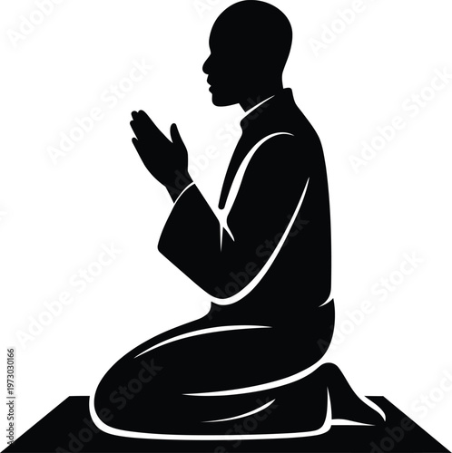 Silhouette of a man kneeling and praying on a prayer mat facing towards the side in a respectful pose
