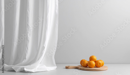A minimalist scene with six oranges on a wooden cutting board against a white wall. Soft light filters through white curtains, creating a serene atmosphere.