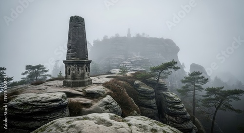 Misty Morning View of a Historic Monument on a Rocky Outcrop in a Forested Landscape.