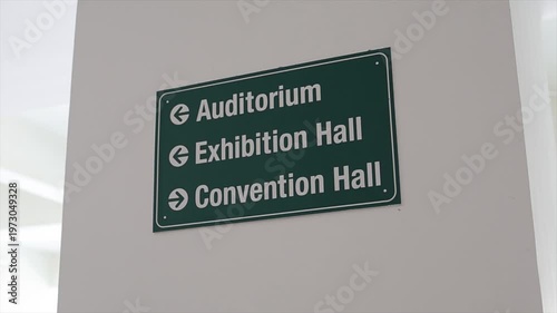 Directional Signage for Auditorium Exhibition Hall and Convention Hall on White Interior Wall..
