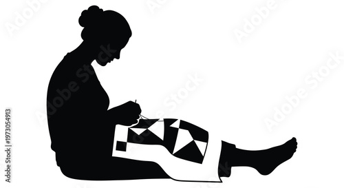 Woman seated crafting a geometric quilt presented as a striking silhouette