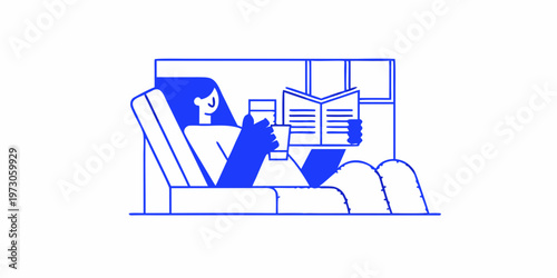 Woman relaxing in an armchair reading a book with a beverage
