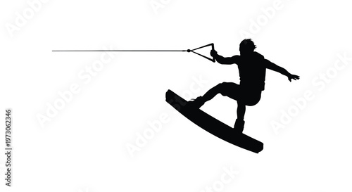 Wakeboarding action shot featuring a dynamic rider in black silhouette