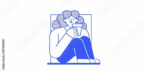Woman with wavy hair enjoys a warm drink curled up in thought