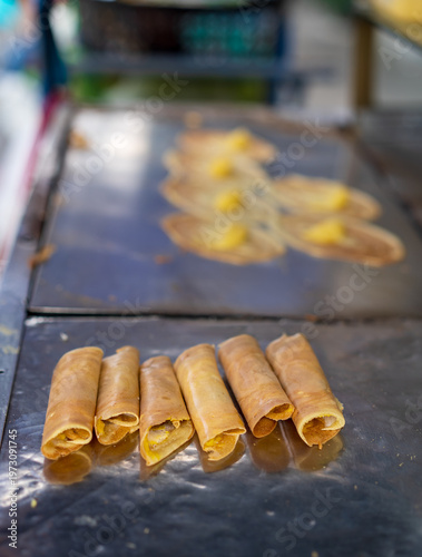 Tokyo pancakes with cream and quail eggs or fresh pile soft waffle roll dessert with custard sales by merchants in local market and street food for traditional sweet snack in bangkok at thailand