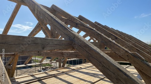 Wooden roof frame structure under construction.