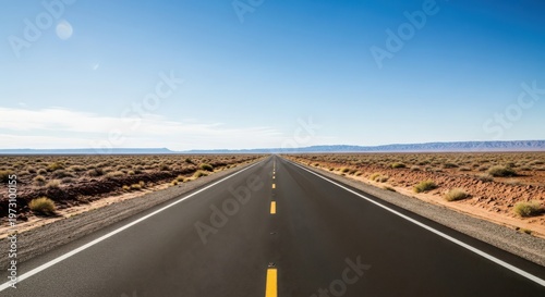 An endless desert highway stretching towards the horizon under a clear blue sky, inviting a sense of open road adventure.