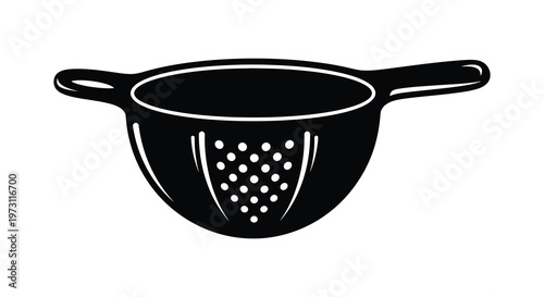 Black colander with perforated design a striking kitchen tool silhouette