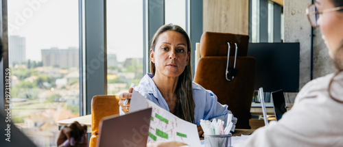 Senior leader discusses strategic development and data insights with team