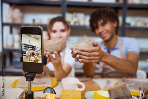Young adults celebrating pottery creation in studio
