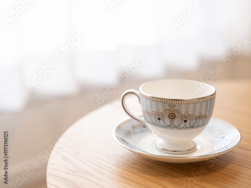 Elegant teacup on round table with copy space