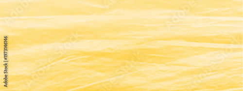 Golden yellow halftone texture, soft waves, dot halftone pattern dunes in the desert. Abstract background with warm tones and gentle soft folds. Crumpled cellophane, wrinkled plastic, packaging film.