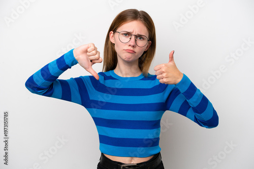 Young English woman isolated on white background making good-bad sign. Undecided between yes or not