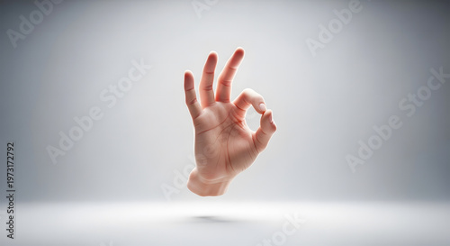 Human hand showing okay gesture against white background with shadow