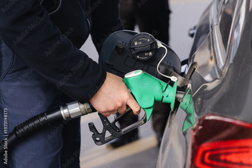 Ταπετσαρία Close up of refueling car with green fuel nozzle at gas station