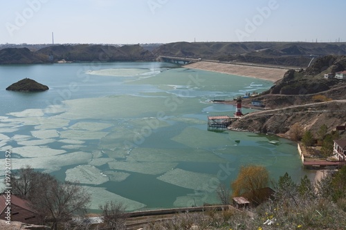Early spring water surface with ice.  Kapshagay Reservoir. Konaev city.
