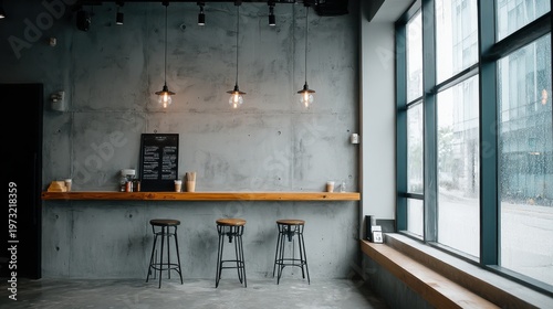 Modern minimalist cafe interior with concrete walls, wooden counter, and industrial pendant lights, large window view