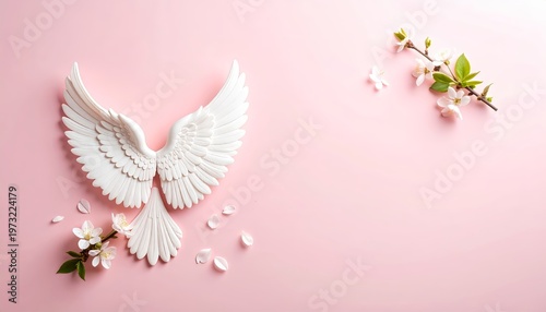 Elegant angel wings and blossom display on a soft pink backdrop creation