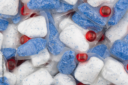 Dishwasher tablet texture background. Macro shot.
Dishwasher detergent tablets. Tablets for cleaning dishes Detergent or cleaning agent.