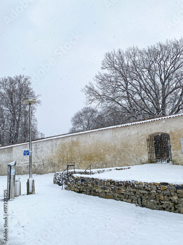 White snowy, fairy tale village, houses, castle and tower covered by snow in winter in Cesky Krumlov, UNESCO world heritage site in the South Bohemian region, Czech republic, Czechia 
