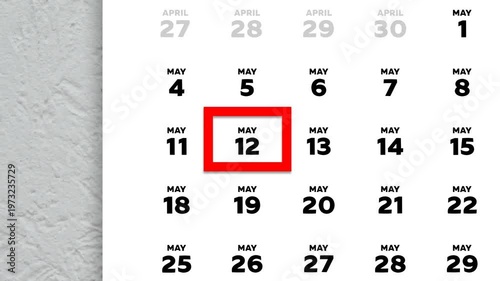 The date May 12th marked with a red cursor on the wall calendar 2026
