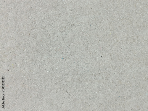 Textura de papel reciclado en color gris claro con pequeñas motas oscuras y grano fino
