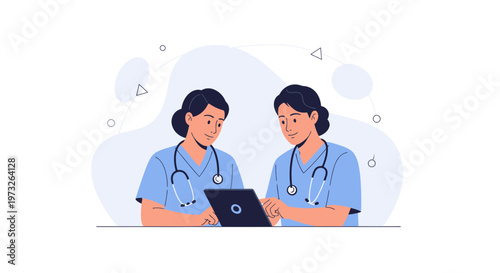 Two nurses in blue scrubs looking at a laptop together, discussing medical information.