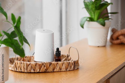 Photos Tray with air humidifier and essential oils on shelf in room, closeup