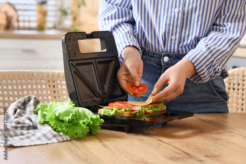 Woman using modern sandwich...