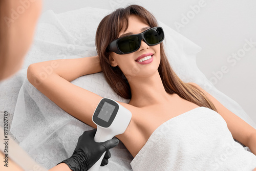 Female cosmetologist using ...
