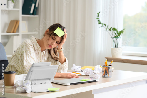 Tired young businesswoman w...