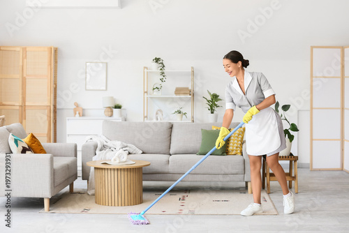 Female janitor mopping floo...