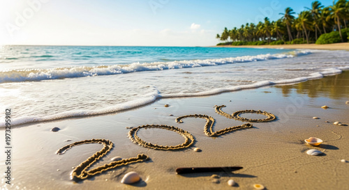 Sandy beach with turquoise water and palm trees. The number 2026 is drawn on the sand, symbolizing a forthcoming year, holidays and travel