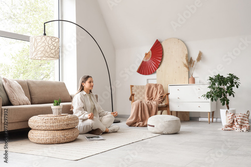 Beautiful young woman medit...