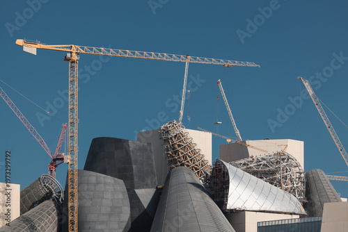 Construction site of modern commercial buildings cranes and industrial machines at day, Abu Dhabi